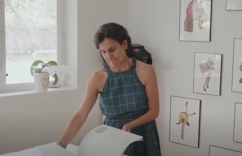 Carol Jazzar looking down at sheets of paper
