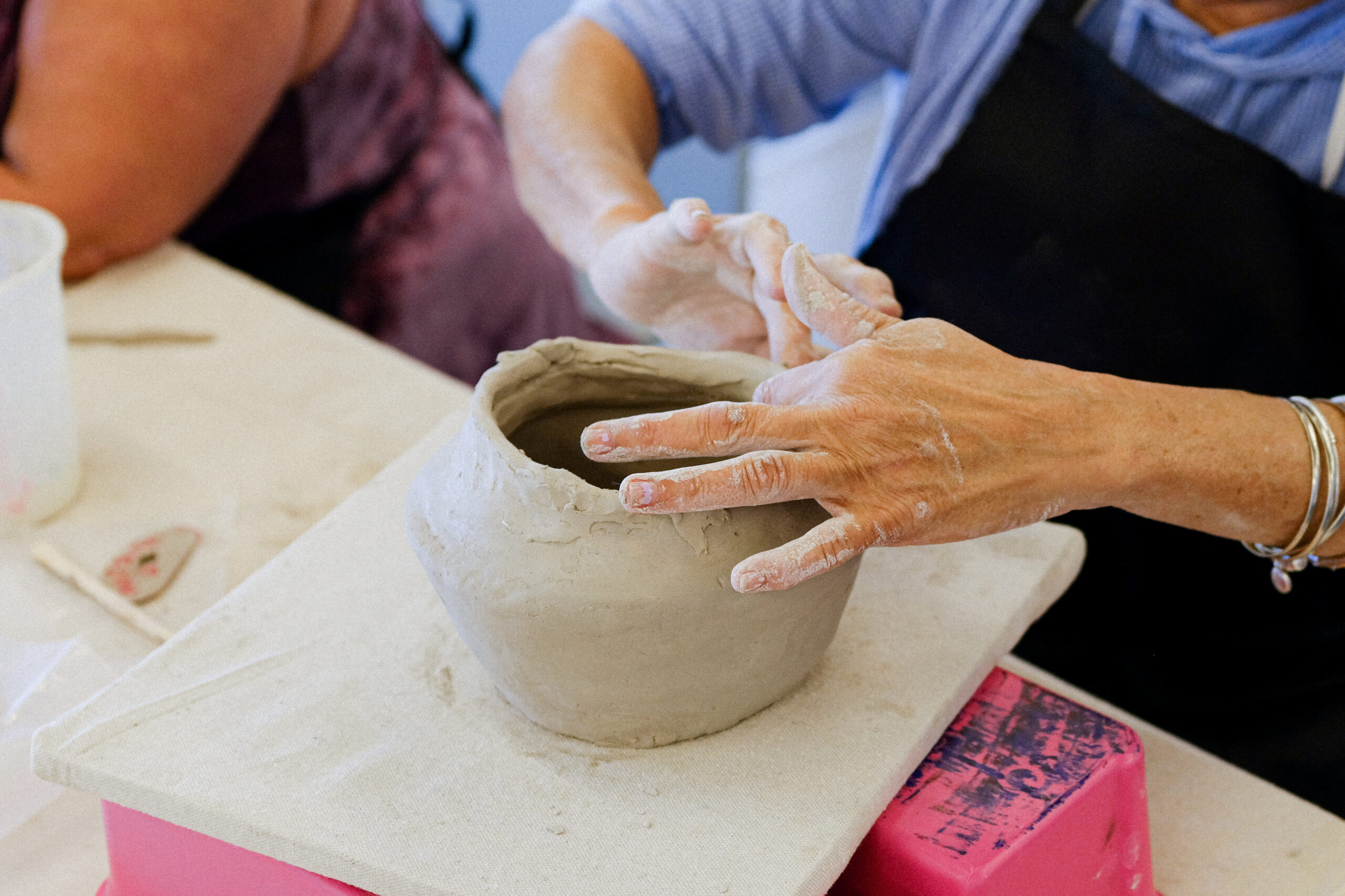 Person making ceramic clay pot