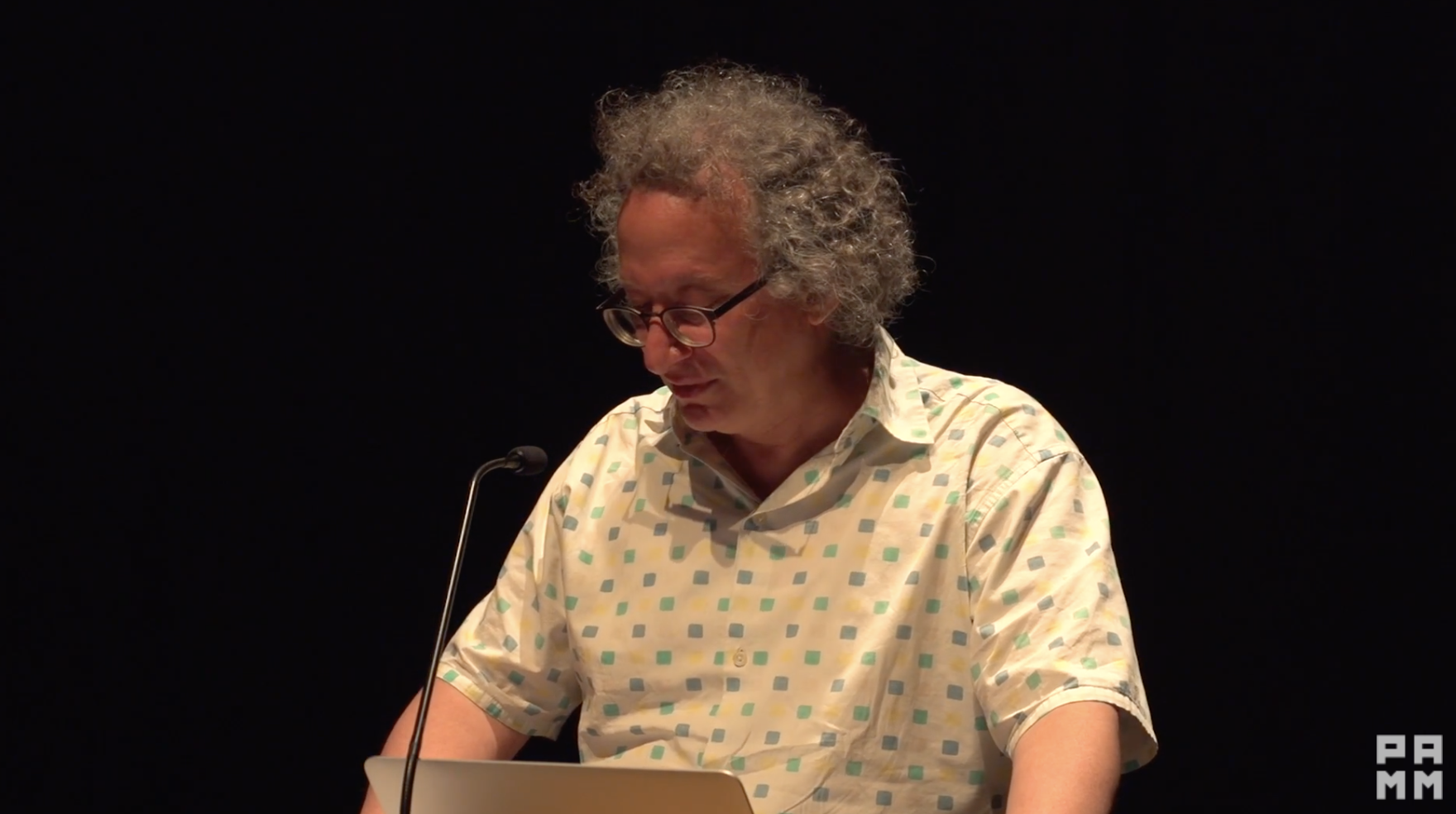 A man presenting on a podium.